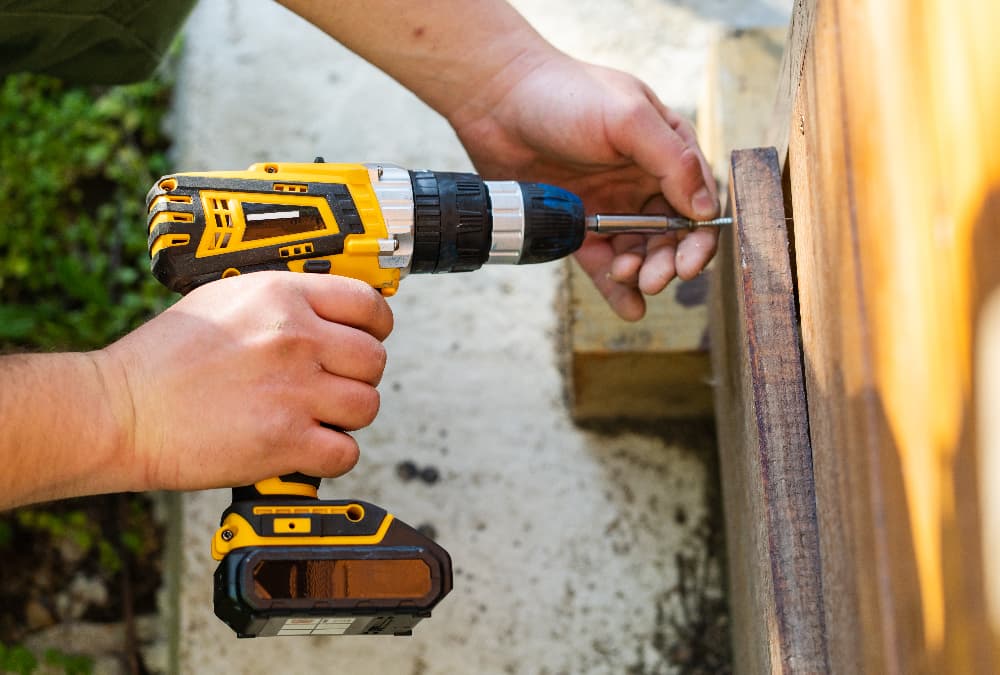 man repairs outdoor wall